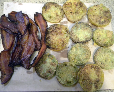 bacon and tomatoes draining on brown paper bag