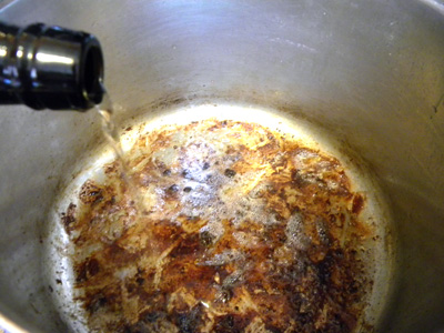 Sherry being added to fond to deglaze the pan
