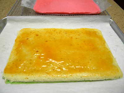 <em>green and white with apricot preserves, ready for red layer</em>