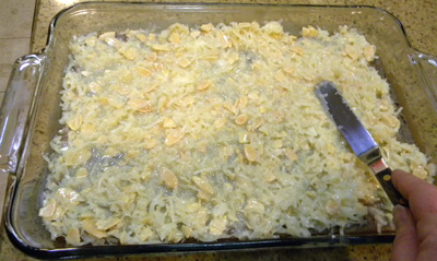 Spreading coconut-almond layer onto partially baked crust