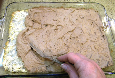 Lastly, spreading frosting on top