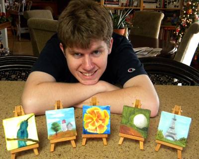 Connor with his paintings, hummingbird for me, barn for Grandpa Otter, flower for Grandma Hopkins, golf ball for Dave, and Eiffel Tower for Marissa.
