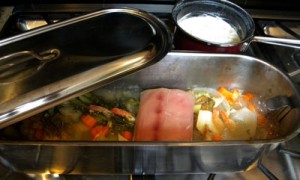 Only the first piece of fish is added here so that the poaching liquid and solids are visible - notice the celery root simmering in the background.